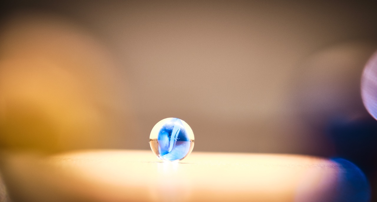 A blue marble shining brightly on a table.