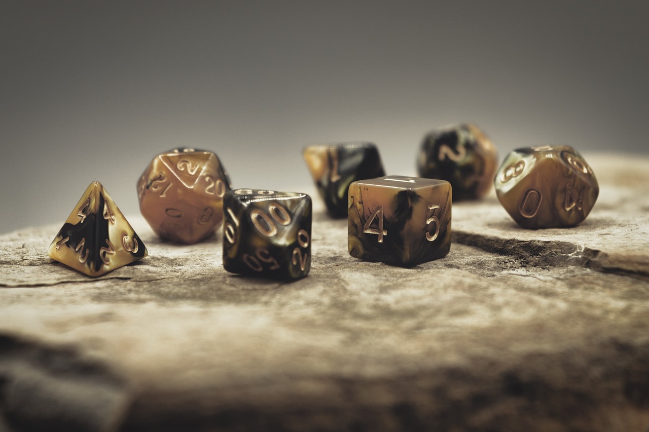 A set of D&D dice laid out on a stone slab, ready to begin.